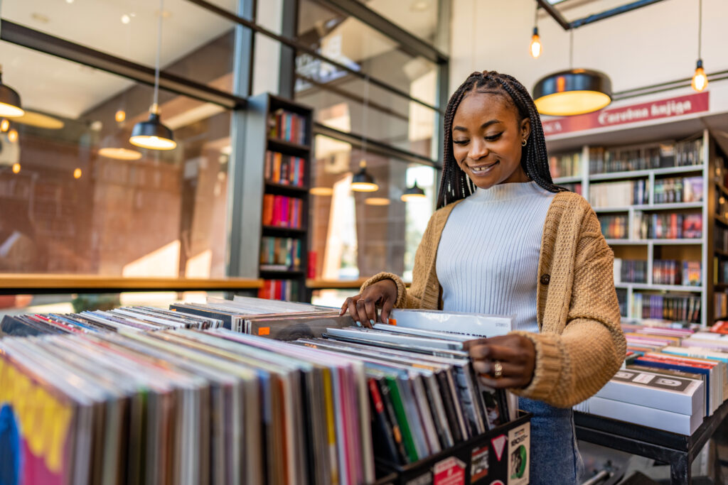Young woman in a vinyl store choosing records.